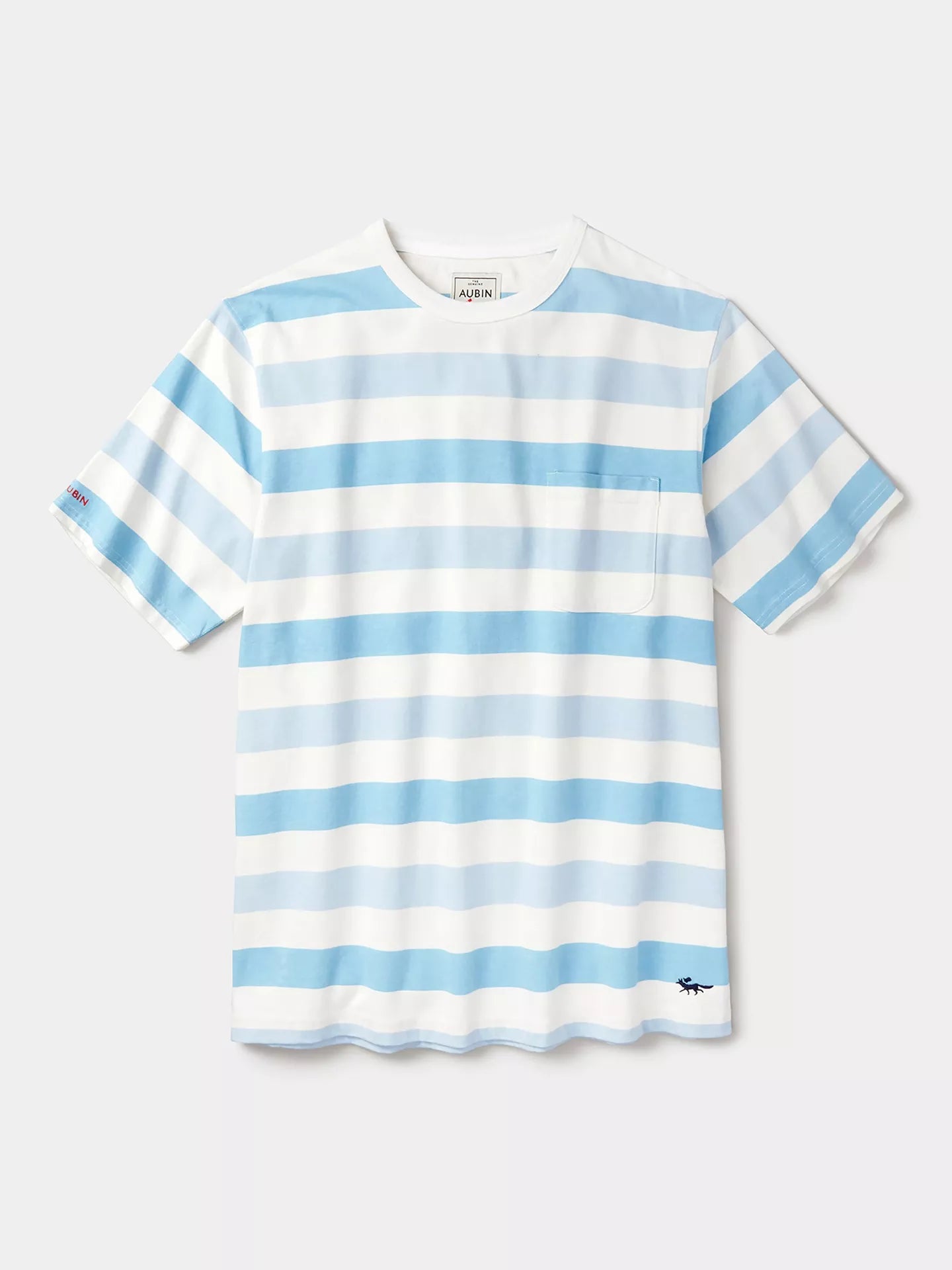 A short-sleeve crewneck t-shirt with horizontal light blue and white stripes, featuring a small chest pocket and a small embroidered logo near the bottom hem.