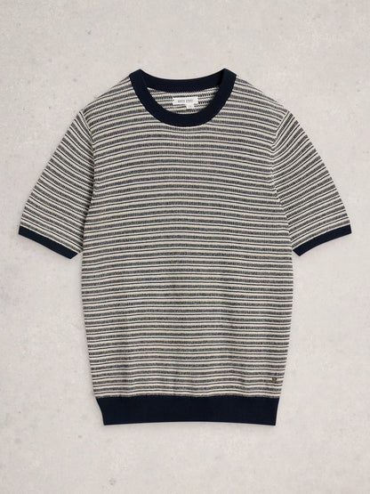 A short-sleeve knit sweater with horizontal black and off-white stripes, featuring solid black ribbed trim at the crew neck, sleeve cuffs, and hem, laid flat on a light textured background.