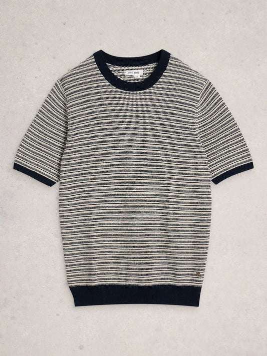 A short-sleeve knit sweater with horizontal black and off-white stripes, featuring solid black ribbed trim at the crew neck, sleeve cuffs, and hem, laid flat on a light textured background.