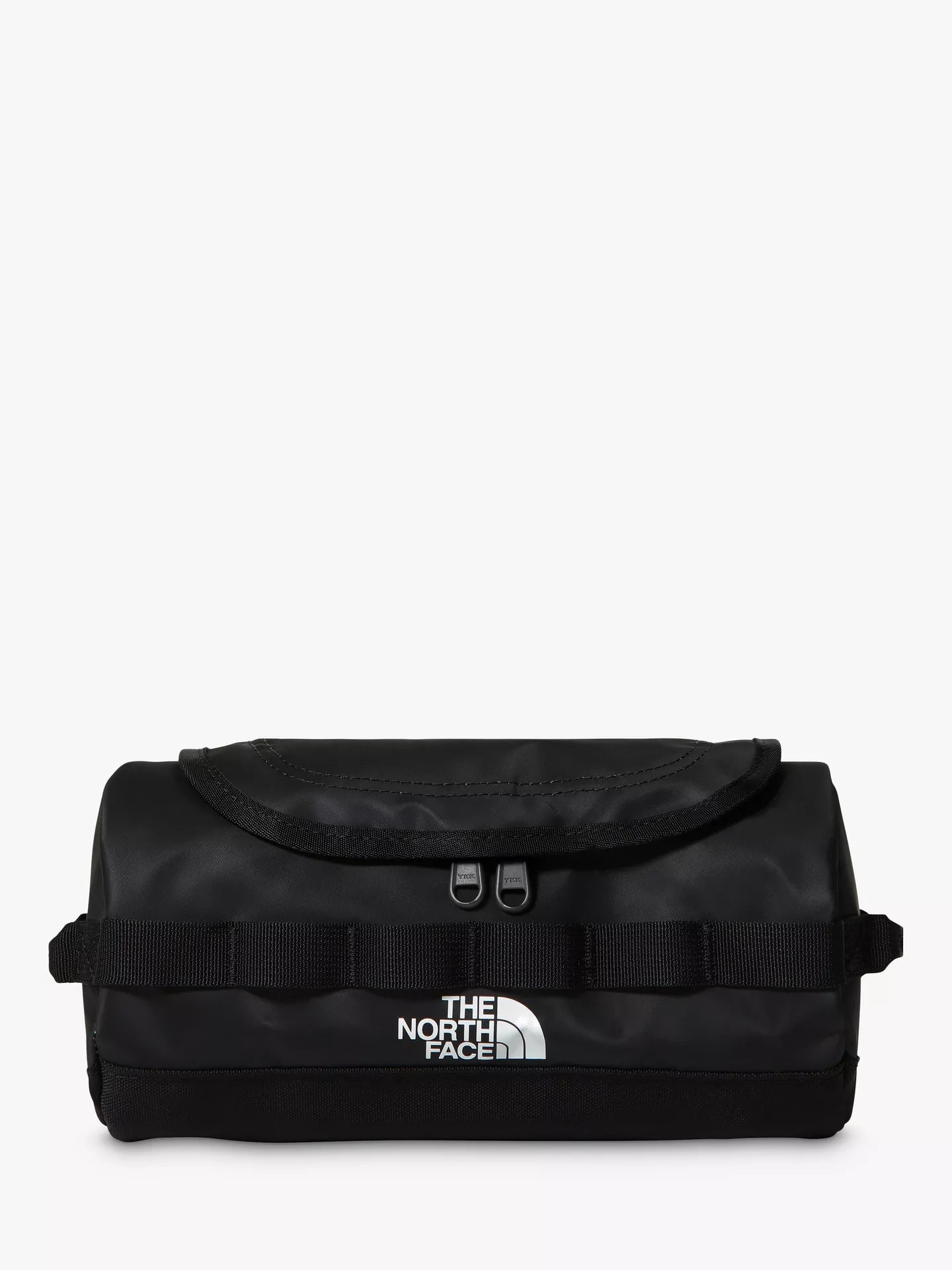 The North Face black canvas tub bag with a front flap, webbing straps, and a white logo on the front, set against a plain white background.