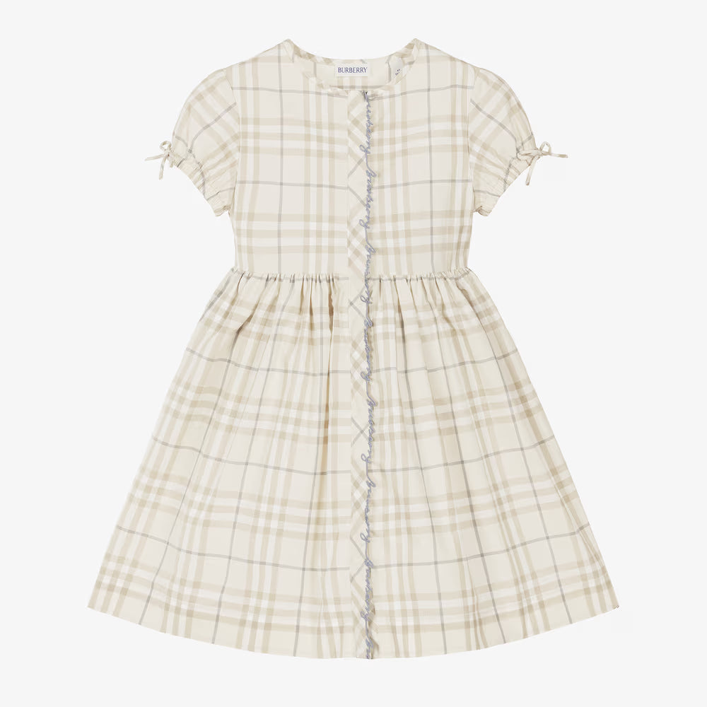 A short-sleeve baby dress in a beige and white plaid pattern, featuring a buttoned front with a decorative lace trim and tie details on the sleeves, shown against a plain white background.