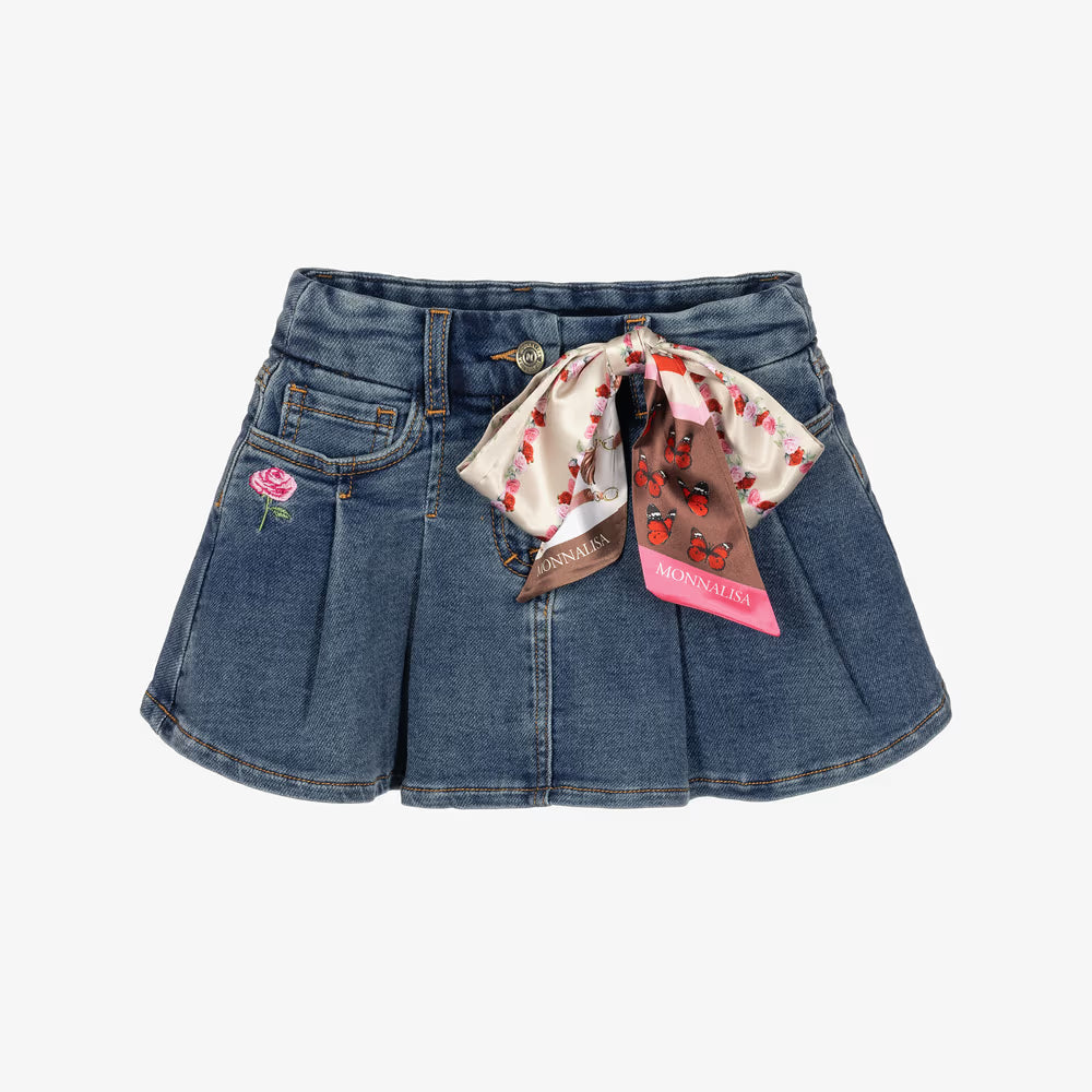 A pair of blue denim shorts featuring pleated detailing, a pink embroidered rose on the left pocket, and a decorative silk bow with a floral print and a pink Morvillo brand tag.