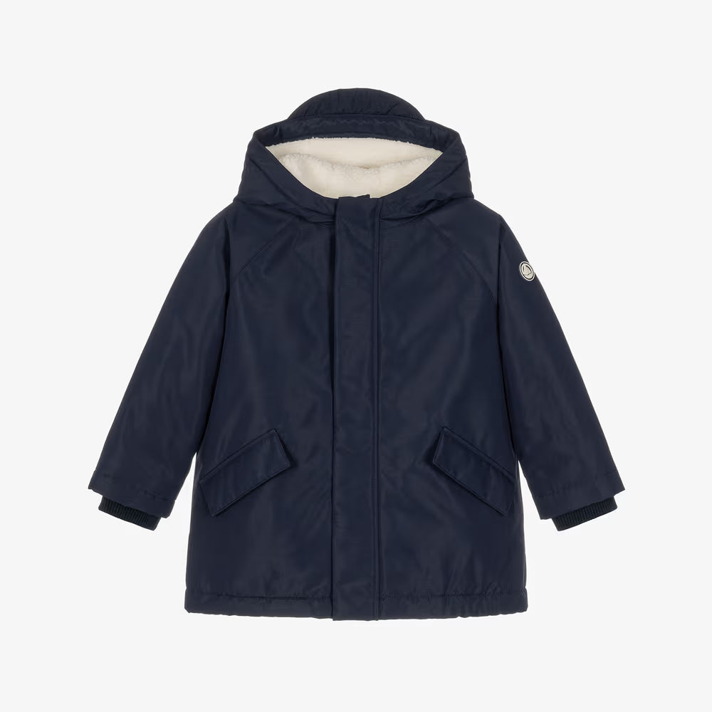 A navy blue hooded winter jacket with a cream-colored fleece lining visible inside the hood, displayed on a clean white background.