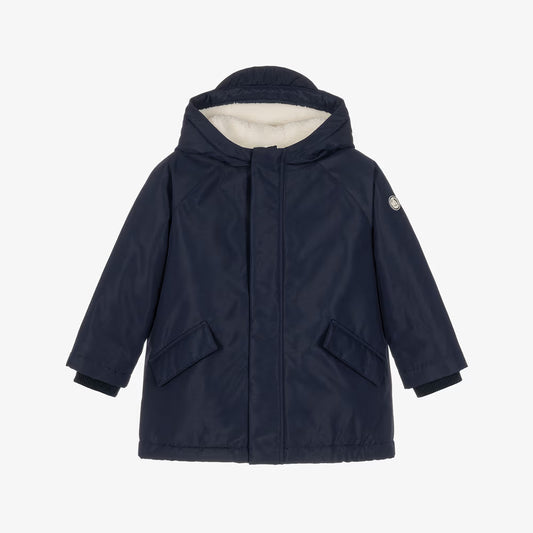 A navy blue hooded winter jacket with a cream-colored fleece lining visible inside the hood, displayed on a clean white background.