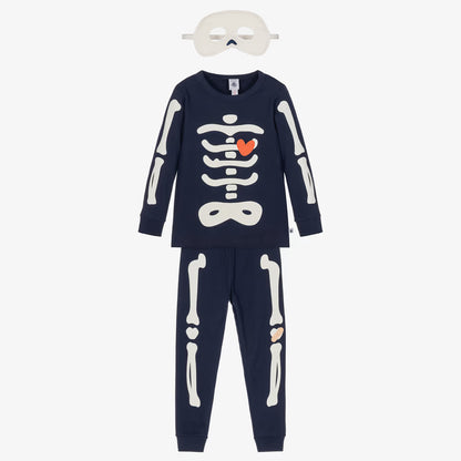 A children's two-piece skeleton-themed pajama set in navy blue, featuring a long-sleeve top and matching pants with white bone graphics. The top has a white rib cage graphic with a small orange heart in the center.