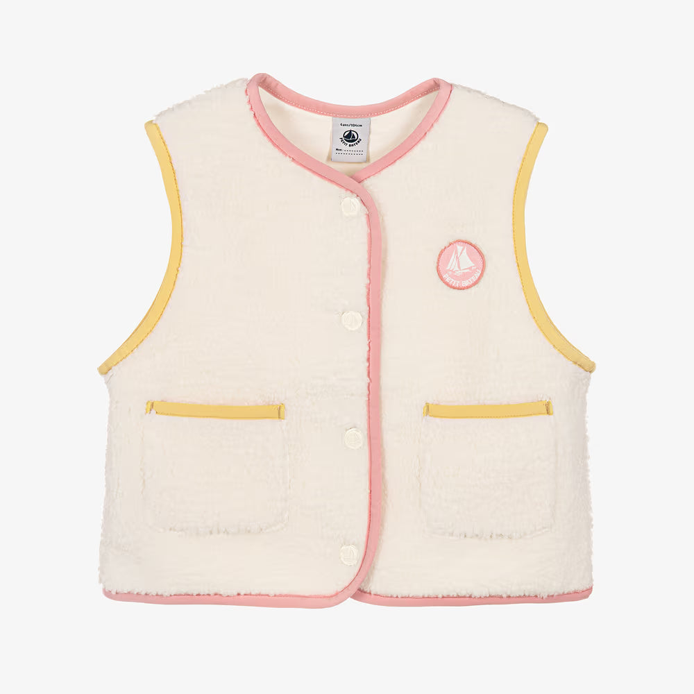 A cream-colored textured fleece vest with pink and yellow trim, featuring a button-up front, two front pockets, and a circular embroidered logo on the left chest.