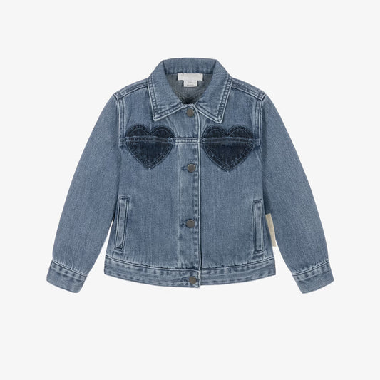 A light blue denim jacket for kids, featuring two dark blue heart-shaped patch pockets on the chest, a button-up front, and a classic collar, shown against a plain white background.