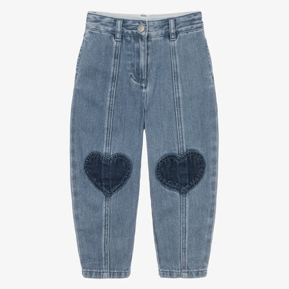 Light blue denim cropped pants with dark blue heart-shaped patchwork details on the front of each leg, shown flat on a light gray background.